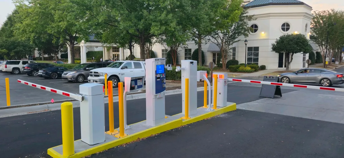 Hotel parking system by Parking BOXX — gated entry and exit lanes with barrier gates and pay stations